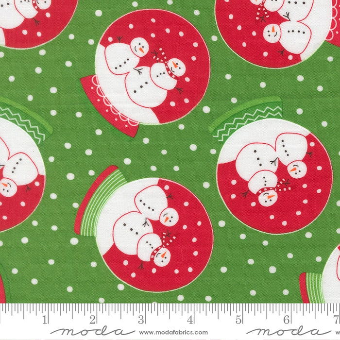 Snow Time Evergreen Snowglobe fabric shown beside a ruler to display the print scale and repeat width