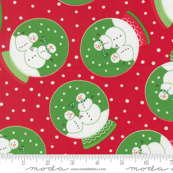 Snow Time Poinsettia Red Snowglobe fabric shown beside a ruler to display the print scale and repeat width