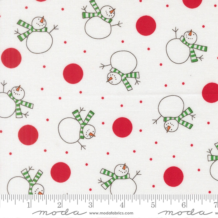 Snow Time Winter White Snowman fabric shown beside a ruler to display the print scale and repeat width