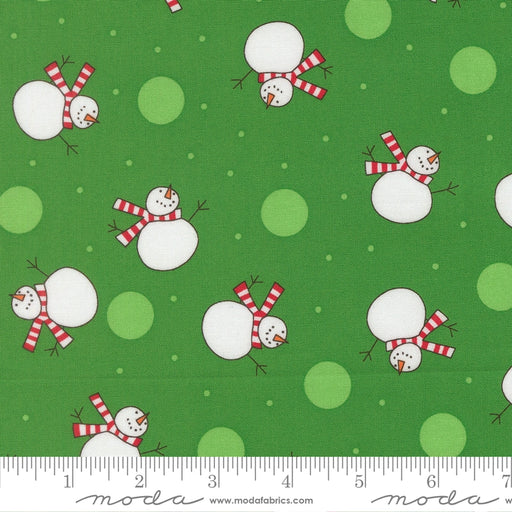 Snow Time Evergreen Snowman fabric shown beside a ruler to display the print scale and repeat width