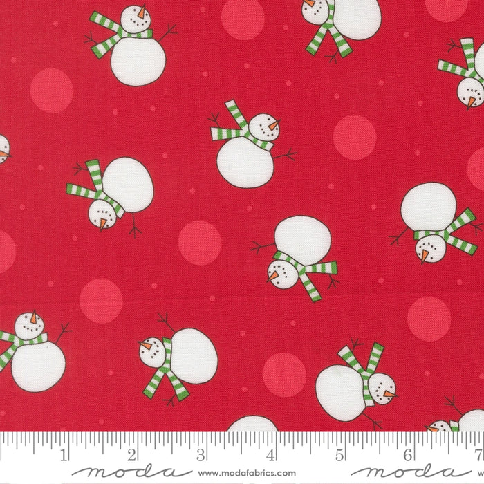 Snow Time Poinsettia Red Snowman fabric shown beside a ruler to display the print scale and repeat width