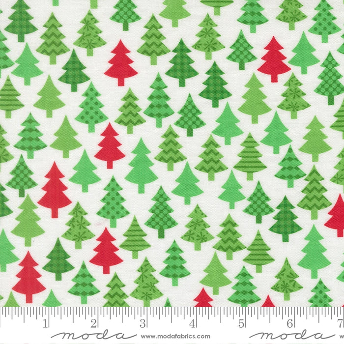 Snow Time Winter White Christmas Trees fabric shown beside a ruler to display the print scale and repeat width