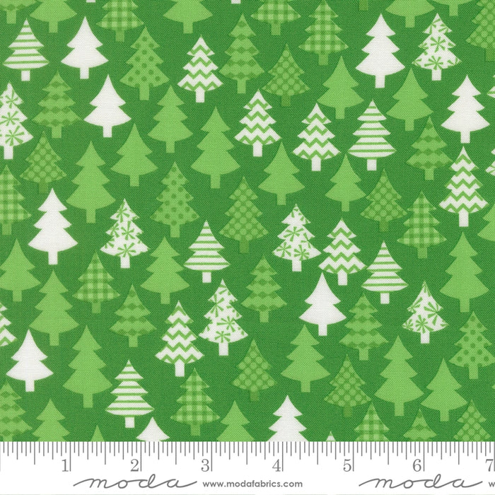 Snow Time Evergreen Christmas Trees fabric shown beside a ruler to display the print scale and repeat width
