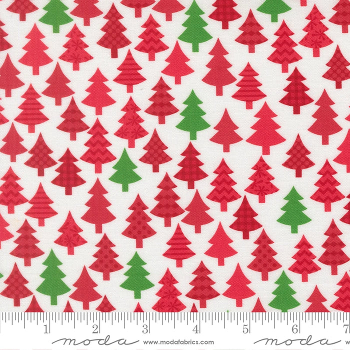 Snow Time Poinsettia Red Christmas Trees fabric shown beside a ruler to display the print scale and repeat width