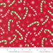 Snow Time Poinsettia Red Candy Cane fabric shown beside a ruler to display the print scale and repeat width
