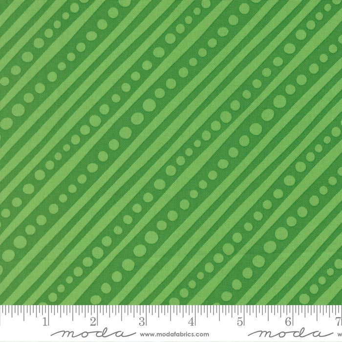 Snow Time Hollyleaf Dotted Bias Stripe fabric shown beside a ruler to display the print scale and repeat width
