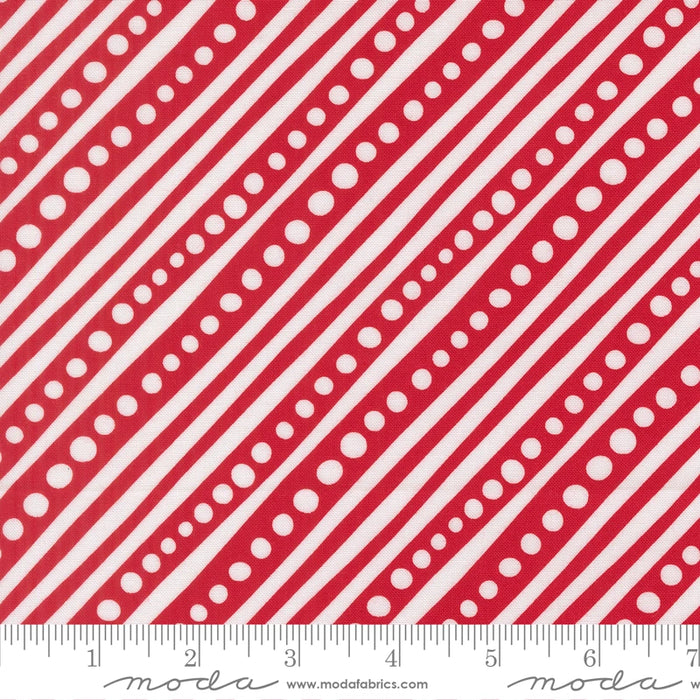 Snow Time Poinsettia Red Dotted Bias Stripe fabric shown beside a ruler to display the print scale and repeat width
