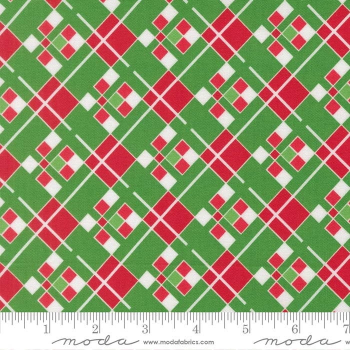 Snow Time Evergreen Plaid fabric shown beside a ruler to display the print scale and repeat width
