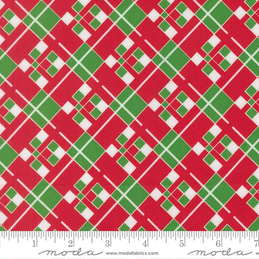 Snow Time Poinsettia Red Plaid fabric shown beside a ruler to display the print scale and repeat width