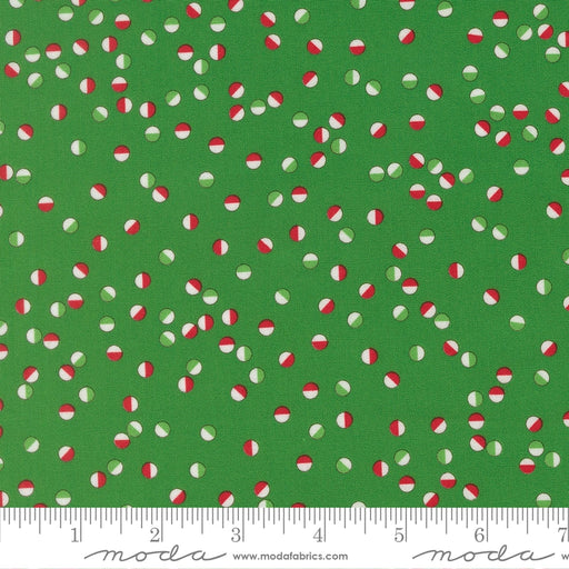 Snow Time Evergreen Jolly Dots fabric shown beside a ruler to display the print scale and repeat width