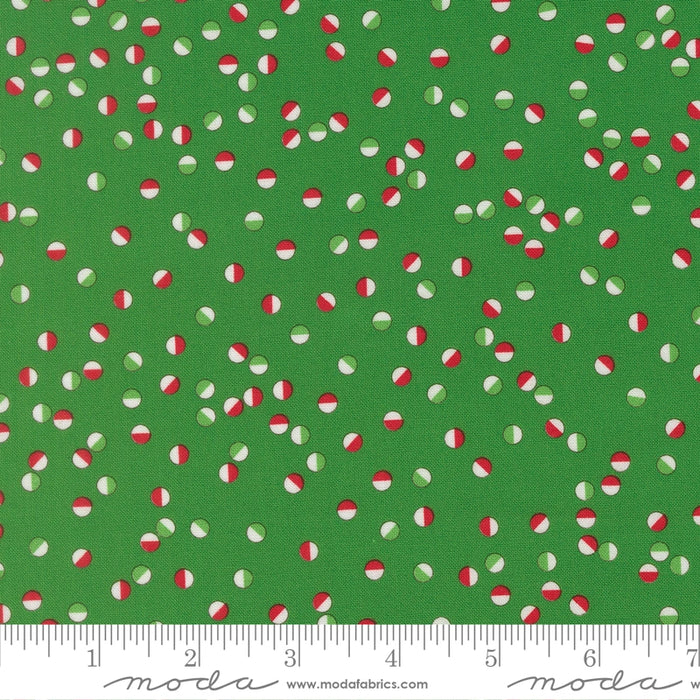 Snow Time Evergreen Jolly Dots fabric shown beside a ruler to display the print scale and repeat width