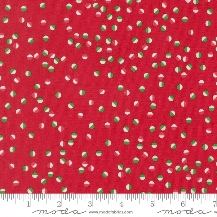 Snow Time Poinsettia Red Jolly Dots fabric shown beside a ruler to display the print scale and repeat width