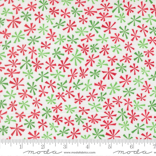 Snow Time Winter White Tinsel fabric shown beside a ruler to display the print scale and repeat width