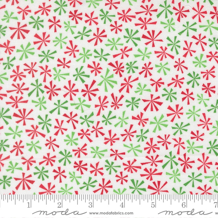 Snow Time Winter White Tinsel fabric shown beside a ruler to display the print scale and repeat width