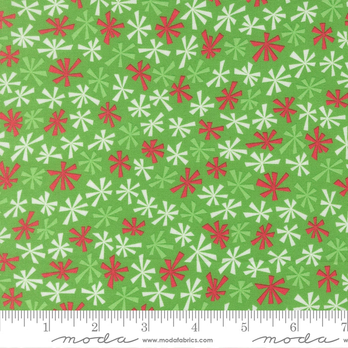 Snow Time Hollyleaf Tinsel fabric shown beside a ruler to display the print scale and repeat width