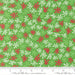 Snow Time Hollyleaf Tinsel fabric shown beside a ruler to display the print scale and repeat width