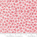 Snow Time Winter White and Red Tinsel fabric shown beside a ruler to display the print scale and repeat width