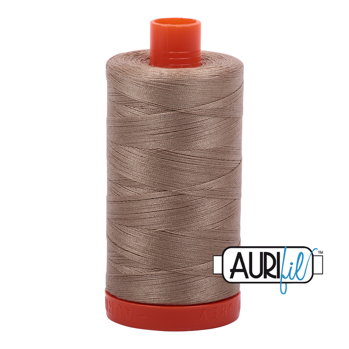 A spool of Aurifil 50wt linen thread in color 2325, which is a neutral grey tone, with the Aurifil logo visible.