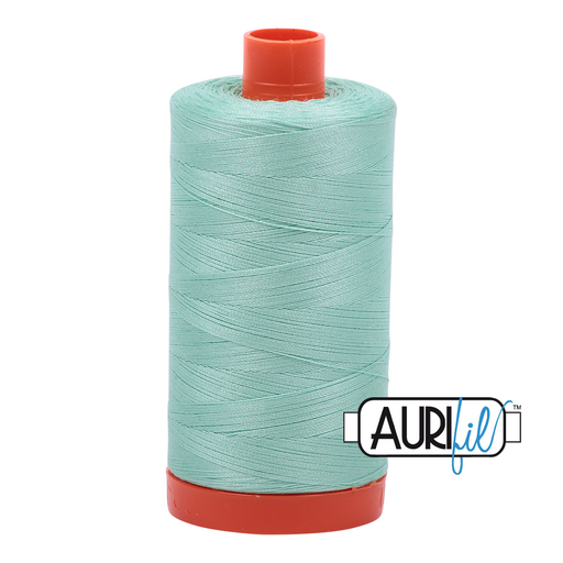 A spool of Aurifil 50wt medium mint colored thread (#2835) with the brand logo visible.