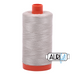 A spool of Aurifil 50wt cotton thread in Moondust color (6725) with orange cap against a white background.