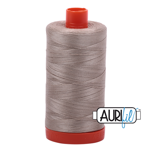 A spool of Aurifil 50wt rope beige cotton thread.