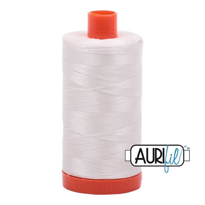 A spool of Aurifil 50wt cotton thread in color Sea Biscuit 6722.