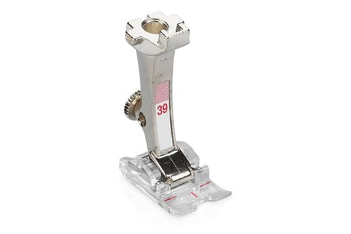 A BERNINA #39 embroidery presser foot with a clear sole, primarily silver in color, used for decorative stitches, appliqués, and buttonhole seams.
