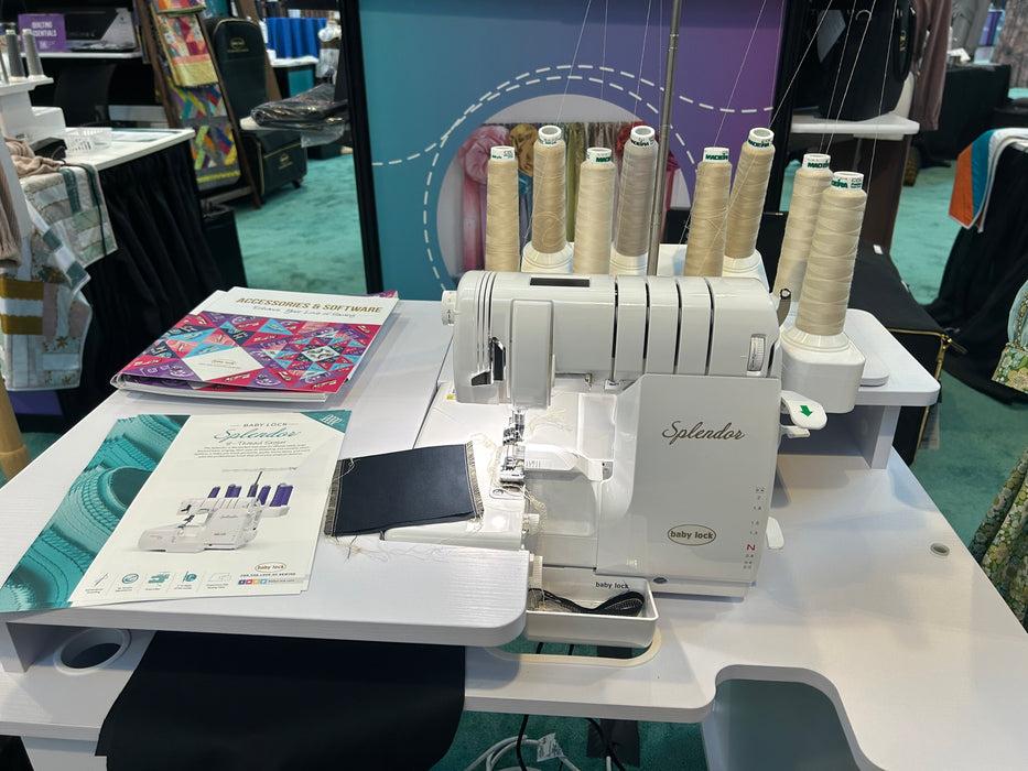 Serger sewing machine with multiple spools of thread on a table.