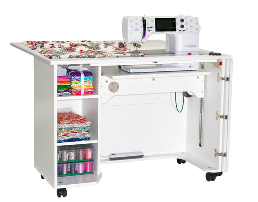 Sewing machine on a Horn of America model 4200 sewing cabinet with elctric lift...with fabric and thread spools on a white background