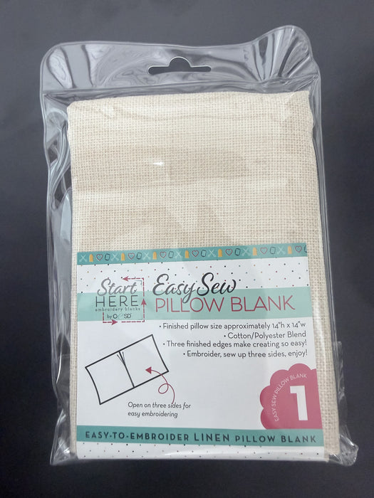 Packaged Easy Sew pillow blank with clear plastic wrapping on a dark background
