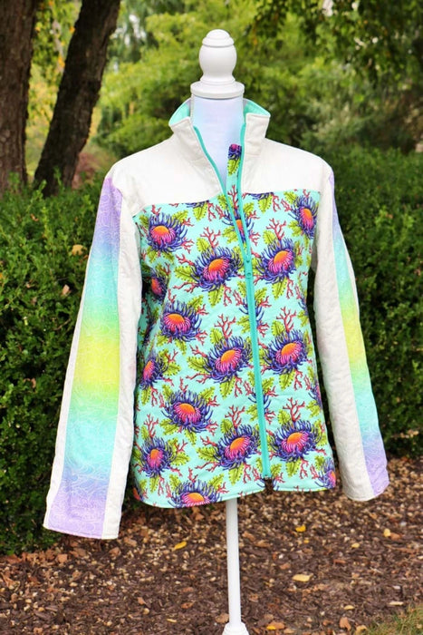 Bella Quilt Coat pattern Colorful jacket with floral pattern on a mannequin outdoors.