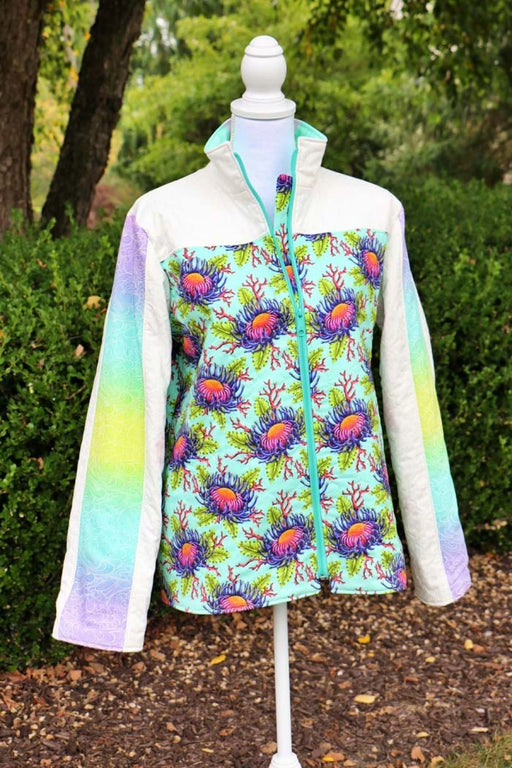 Bella Quilt Coat pattern Colorful jacket with floral pattern on a mannequin outdoors.