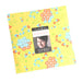 Sherbet sunshine layer cake Yellow fabric with colorful floral pattern and Moda label on a white background