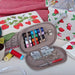 Sewing kit with thread and scissors on a fabric background