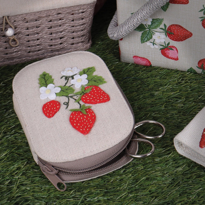 Small sewing kit pouch with strawberry design on grass