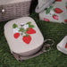 Small sewing kit pouch with strawberry design on grass
