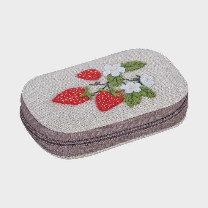 Small rectangular pouch with embroidered strawberries and flowers on a light background