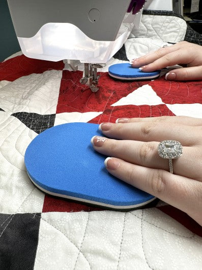 Person using a Gypsy Quilter's Grip & Stitch quilting disks on a quilt for free motion quilting