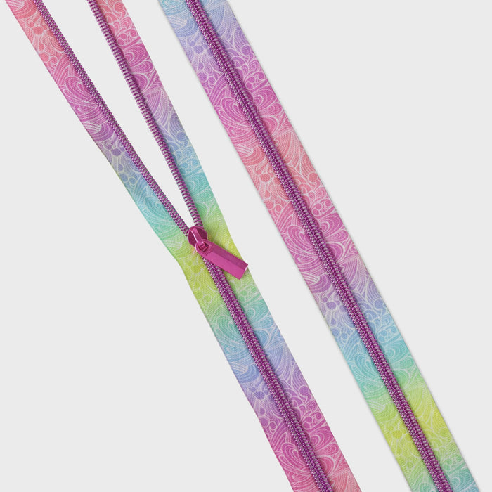 Two colorful zippers with a paisley pattern on a white background from Tula Pink's Floral Reef collection Making Waves
