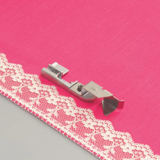 Lace trim and a Baby Lock lace Applicator foot on pink fabric