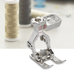 Bernina #20D Open Embroidery Presser Foot made of metal, displayed in front of spools of thread.