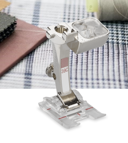 A BERNINA #39C Embroidery Presser Foot with a clear sole, placed on a table with a checkered tablecloth, preparing for embroidery work.