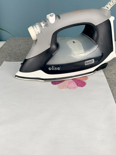 Gray and black iron on a white surface with a blue background