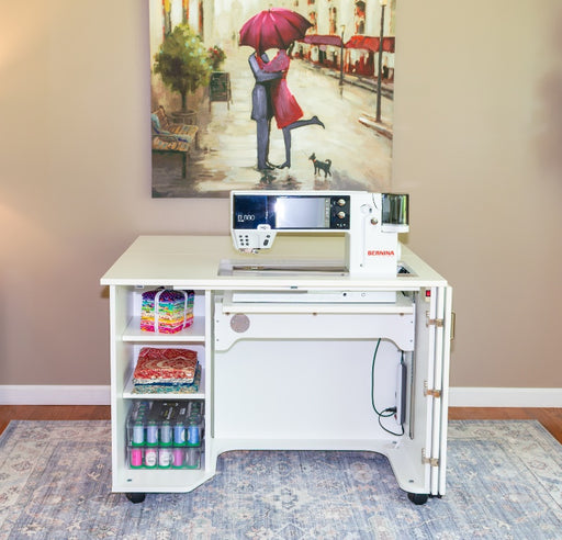 Horn of America Model 4200 White Sewing Cabinet w/ Electric Lift and Bernina machine on it