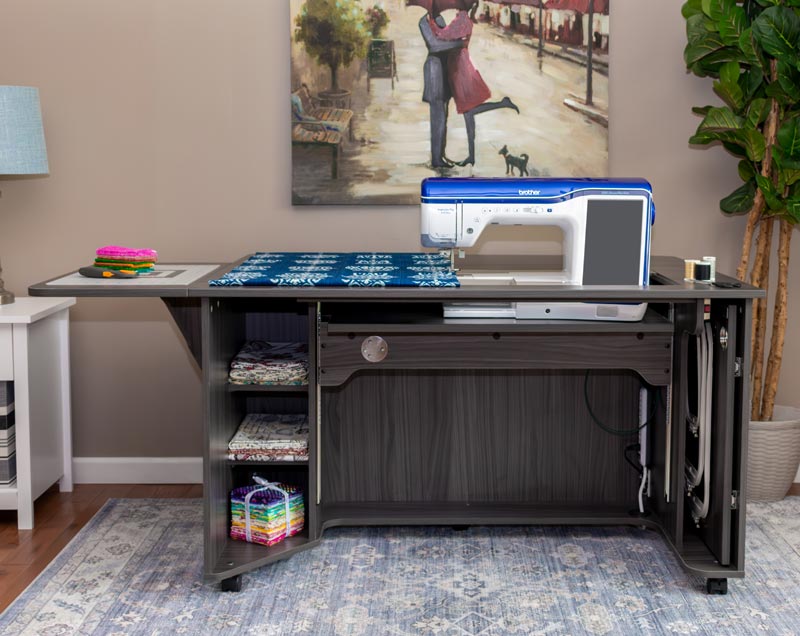 Horn of America Model 9030 Gray Sewing Cabinet with Brother sewing machine on it