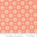 Fabric pattern with floral circles and polka dots on a pink background, featuring Moda label.