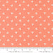 Coral fabric with white tulip pattern and Moda label ruler at the bottom