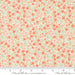 Floral patterned fabric with a ruler at the bottom for scale, featuring pink and green flowers on a light background.