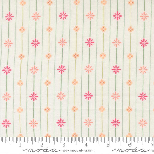 Floral pattern fabric with a ruler for scale on a white background