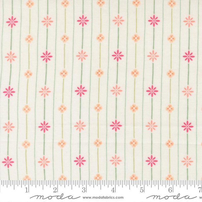Floral pattern fabric with a ruler for scale on a white background